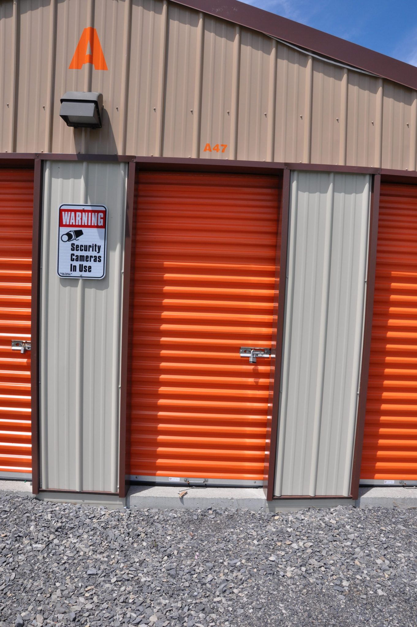 Drive-up unit doors with security camera warning sign